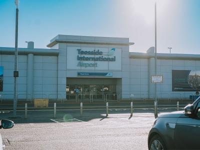 A view of the main entrance to Teesside International Airport on a sunny day.