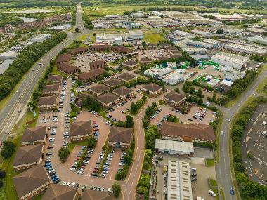 Drone image of Falcon Court at Preston Farm showing buildings with car parking