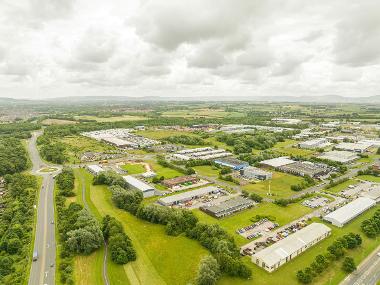 Drone image of Teesdale Industrial Estate showing warehouses and green spaces next to a road